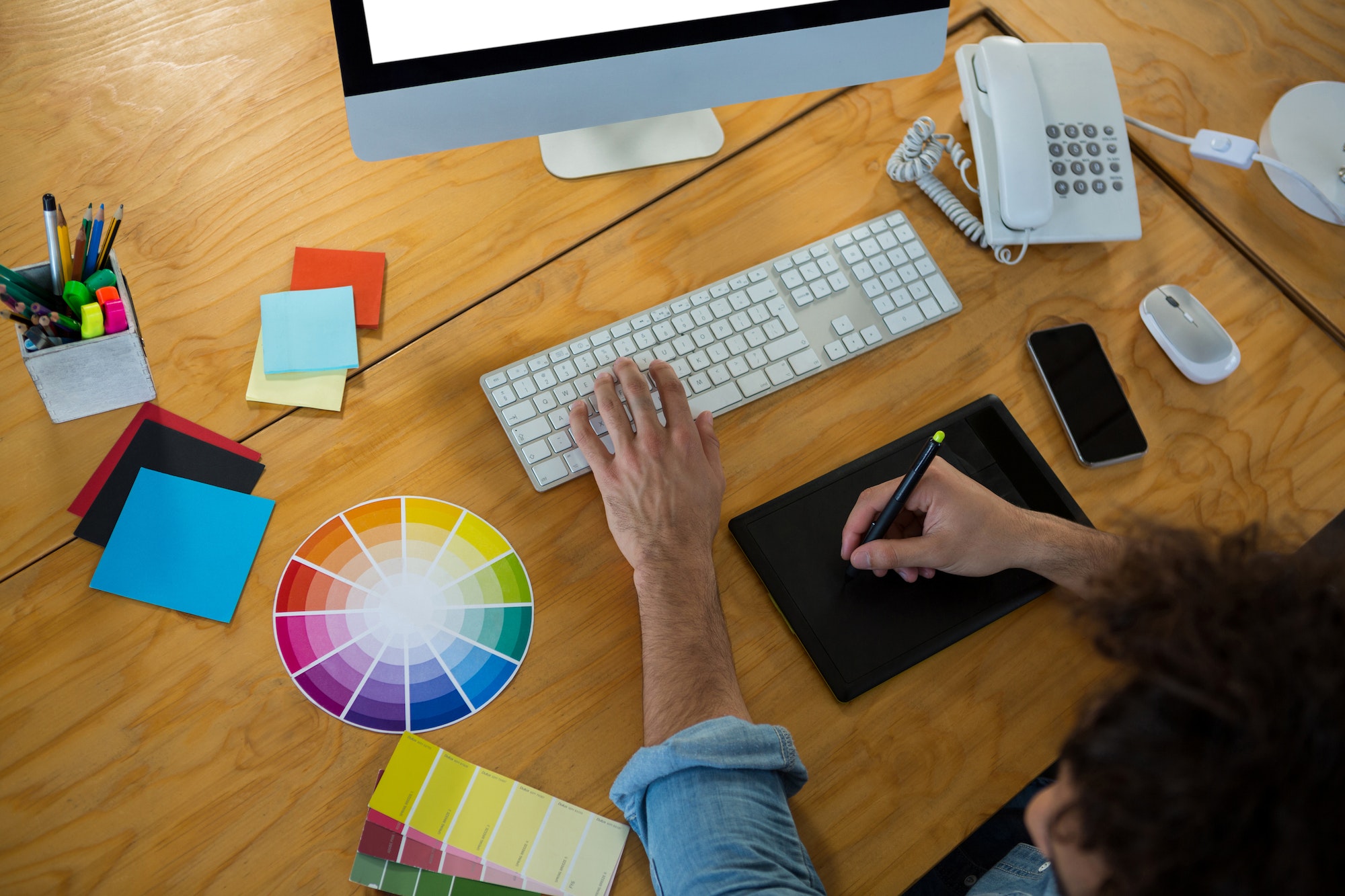 Graphic designer using graphic tablet and desktop